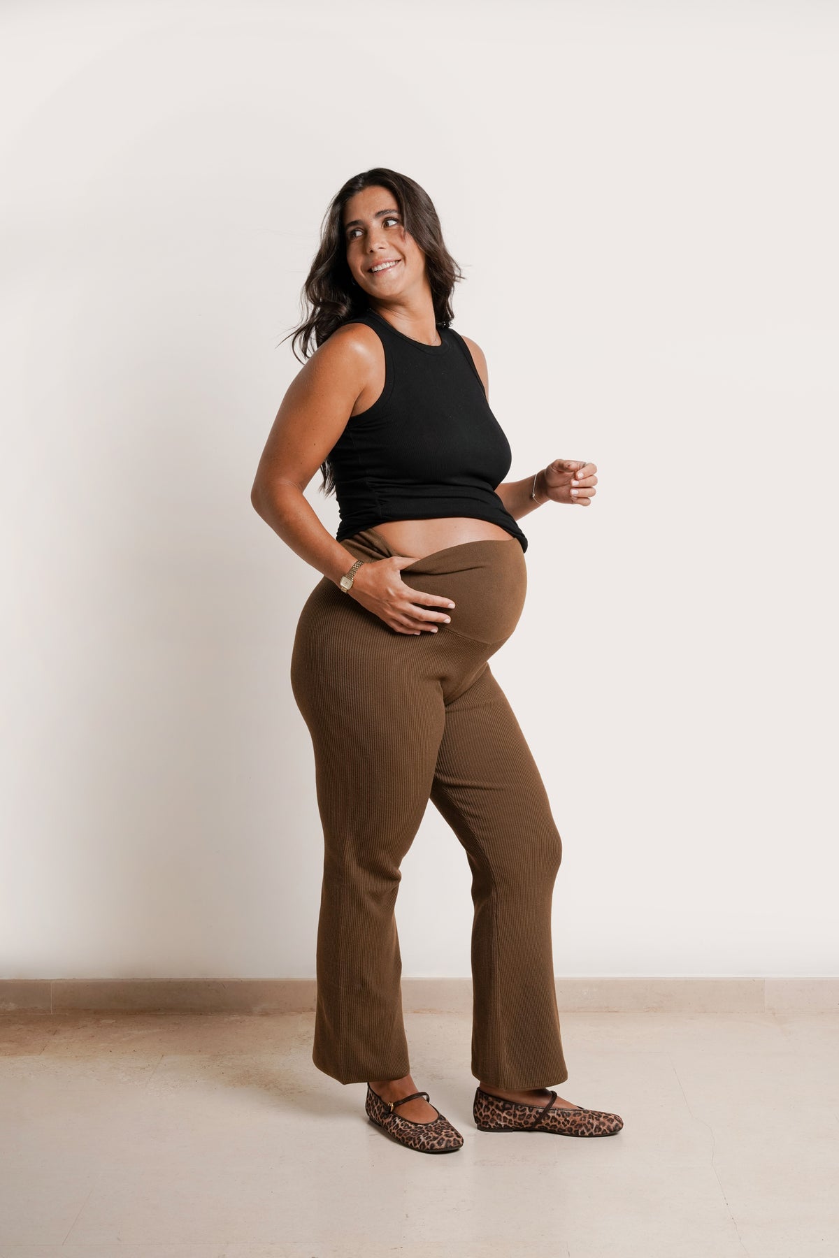NOM Maternity Georgina Knit Pant in Chocolate, side view showing stretch waistband over bump, flare fit