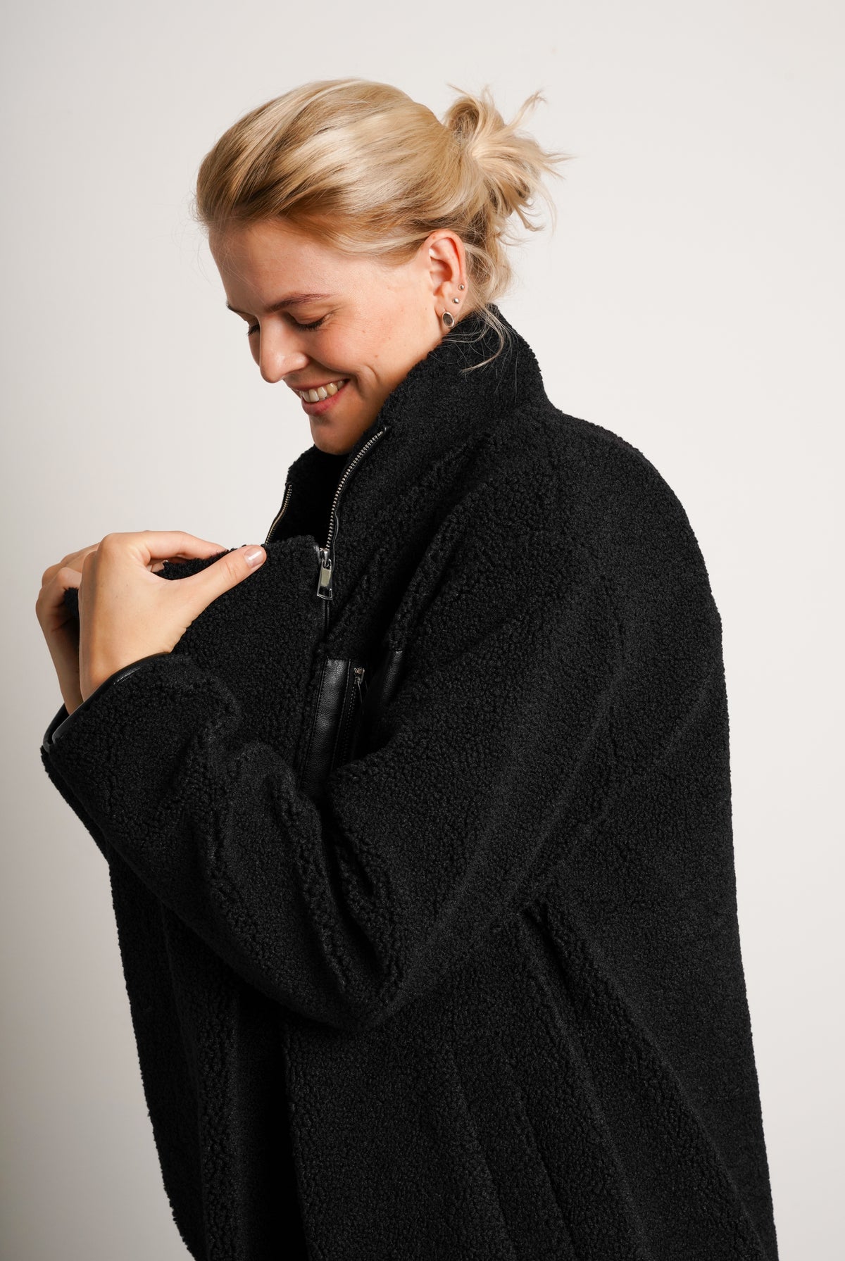 NOM Maternity Teddi Coat in Black, side view showing zipper panel