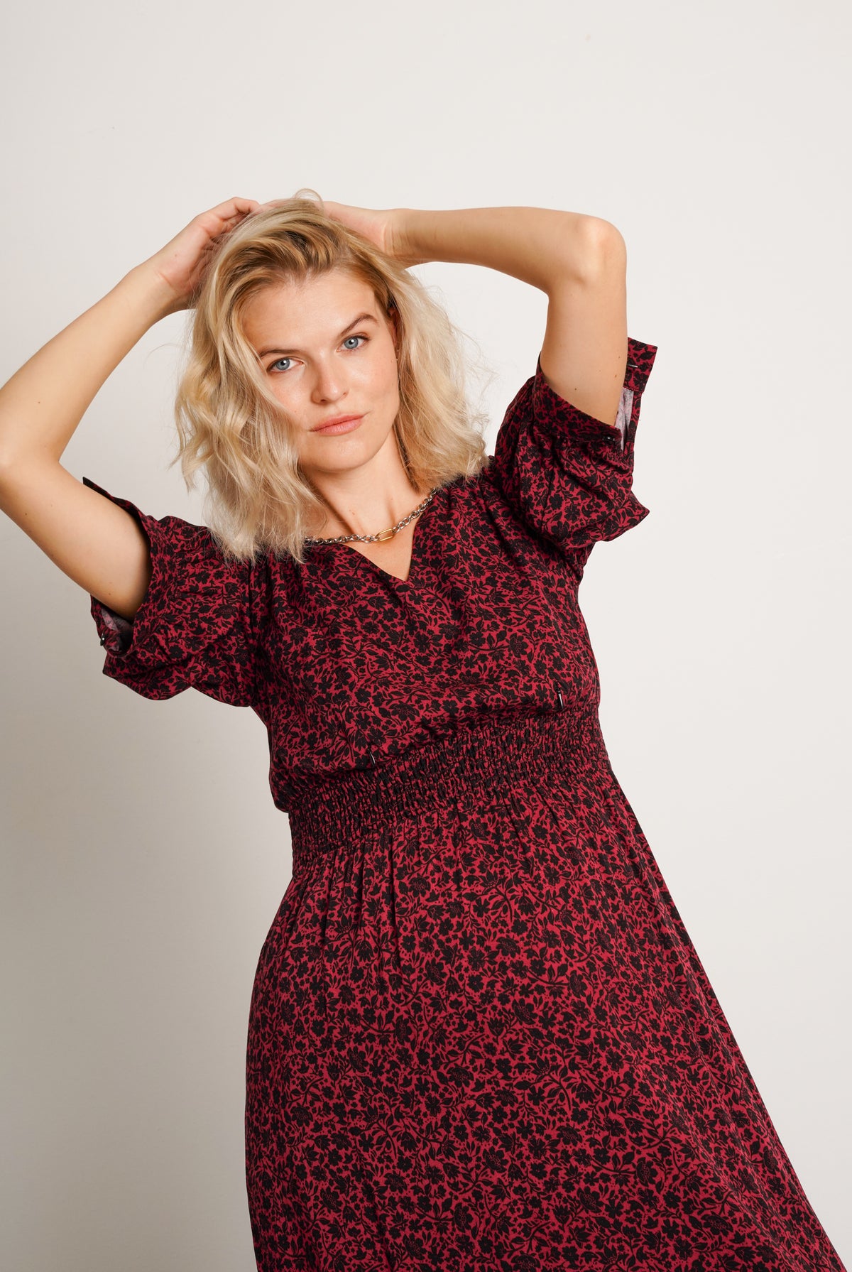 NOM Maternity Leila Dress in Burgundy Floral, close-up front view of sleeve and waist detail