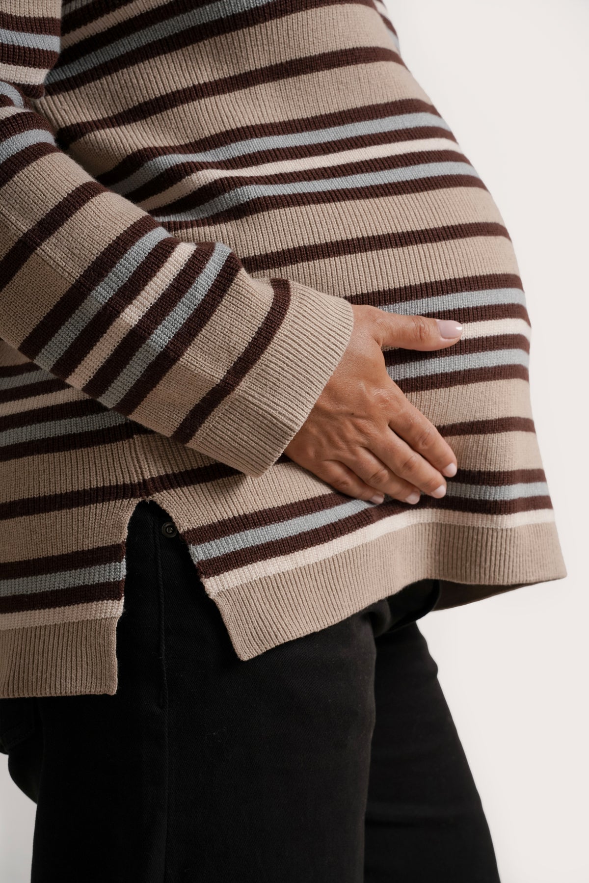 NOM Maternity Blaire 3/4 Zip Sweater in Ice Stripe, close-up view of side slit, showing bump