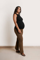 NOM Maternity Georgina Knit Pant in Chocolate, three-quarter view with bump