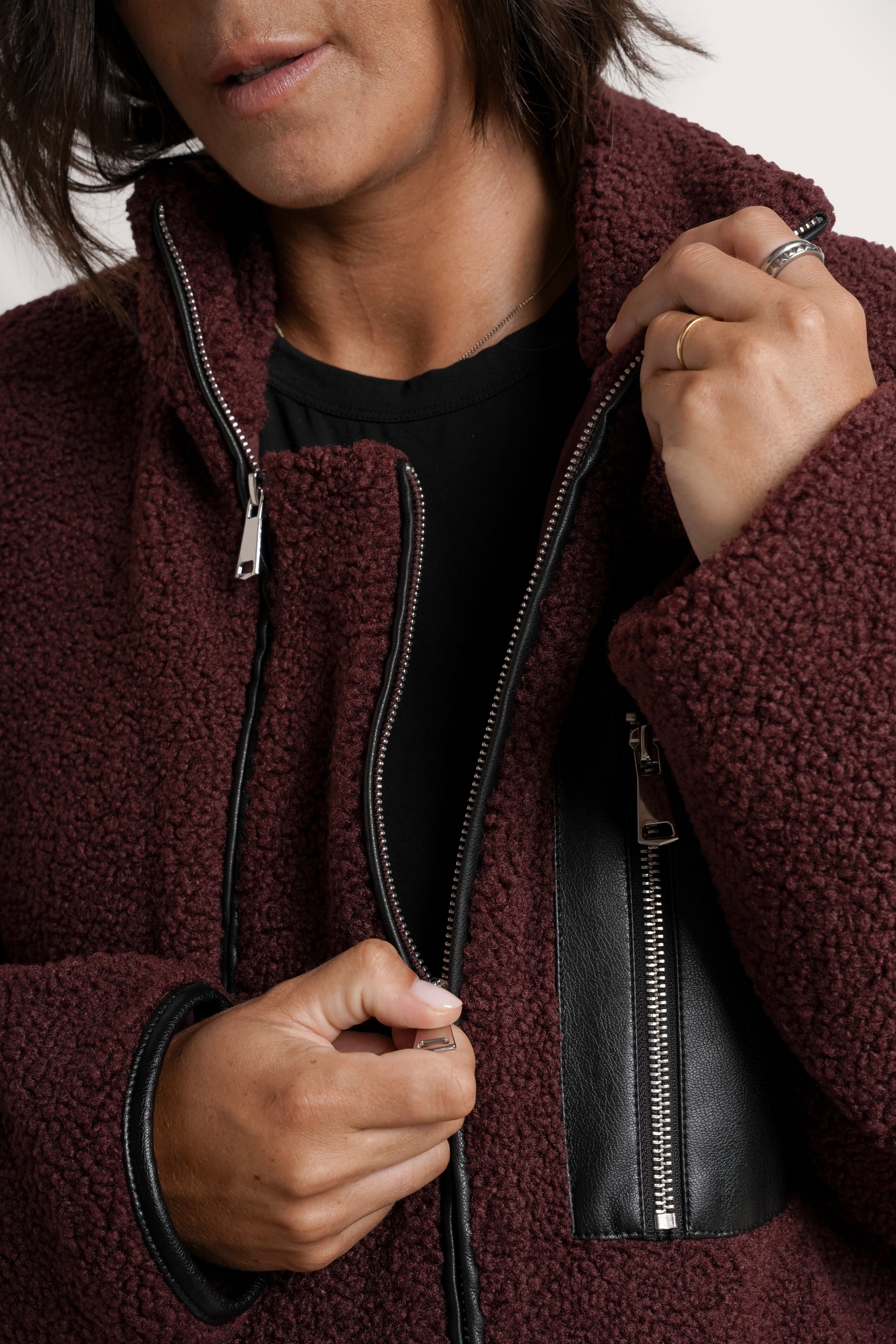 NOM Maternity Teddi Coat in Burgundy, close-up view of front zipper 