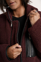 NOM Maternity Teddi Coat in Burgundy, close-up view of front zipper 