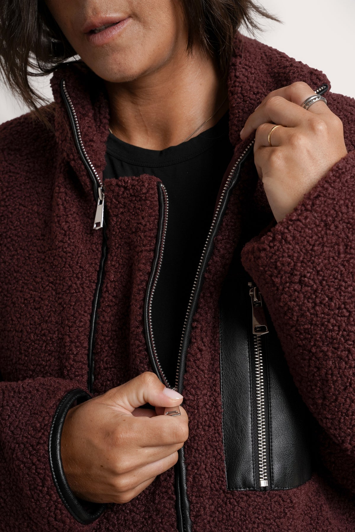 NOM Maternity Teddi Coat in Burgundy, close-up view of front zipper 