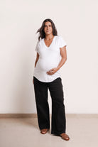 NOM Maternity The Nursing Tee in White, full front view with bump