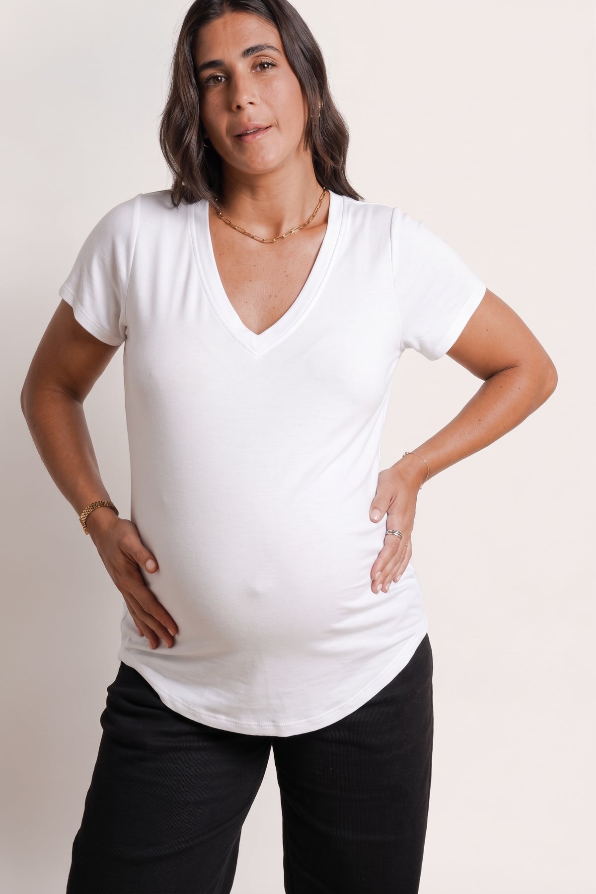 NOM Maternity The Nursing Tee in White, close-up view showing neckline, sleeves and length, with bump